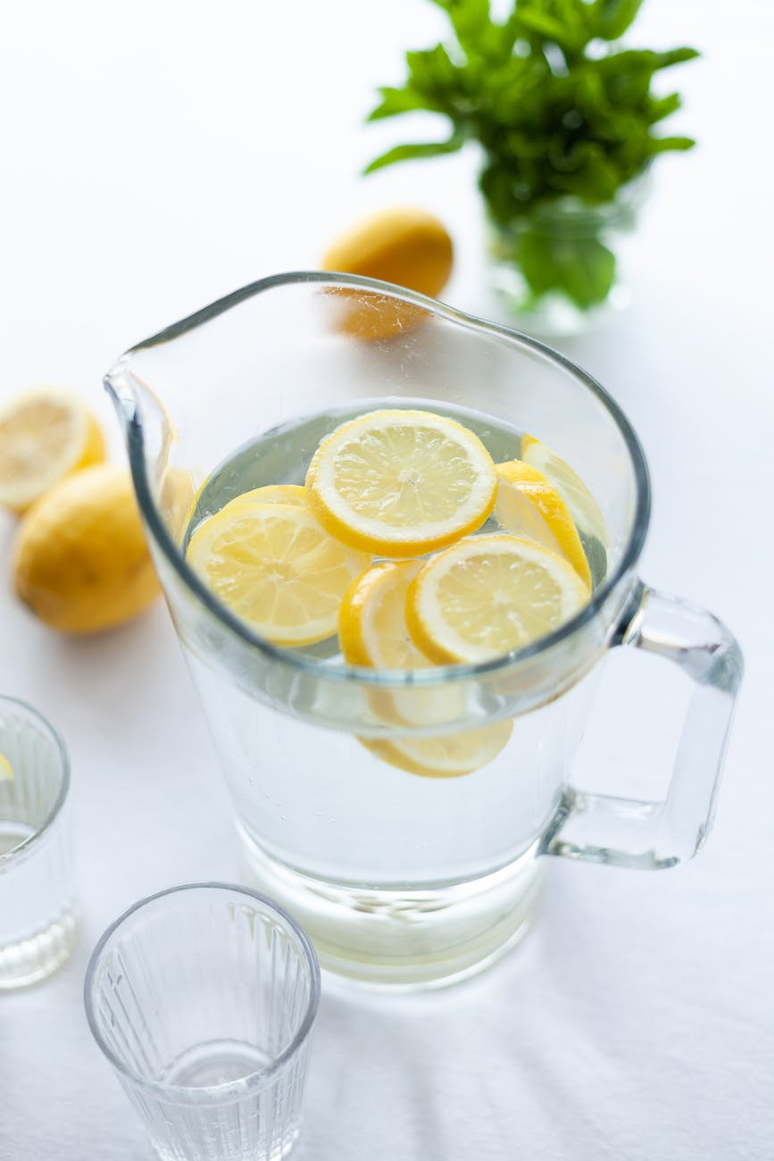 clear glass pitcher filled with water and slices of lemon